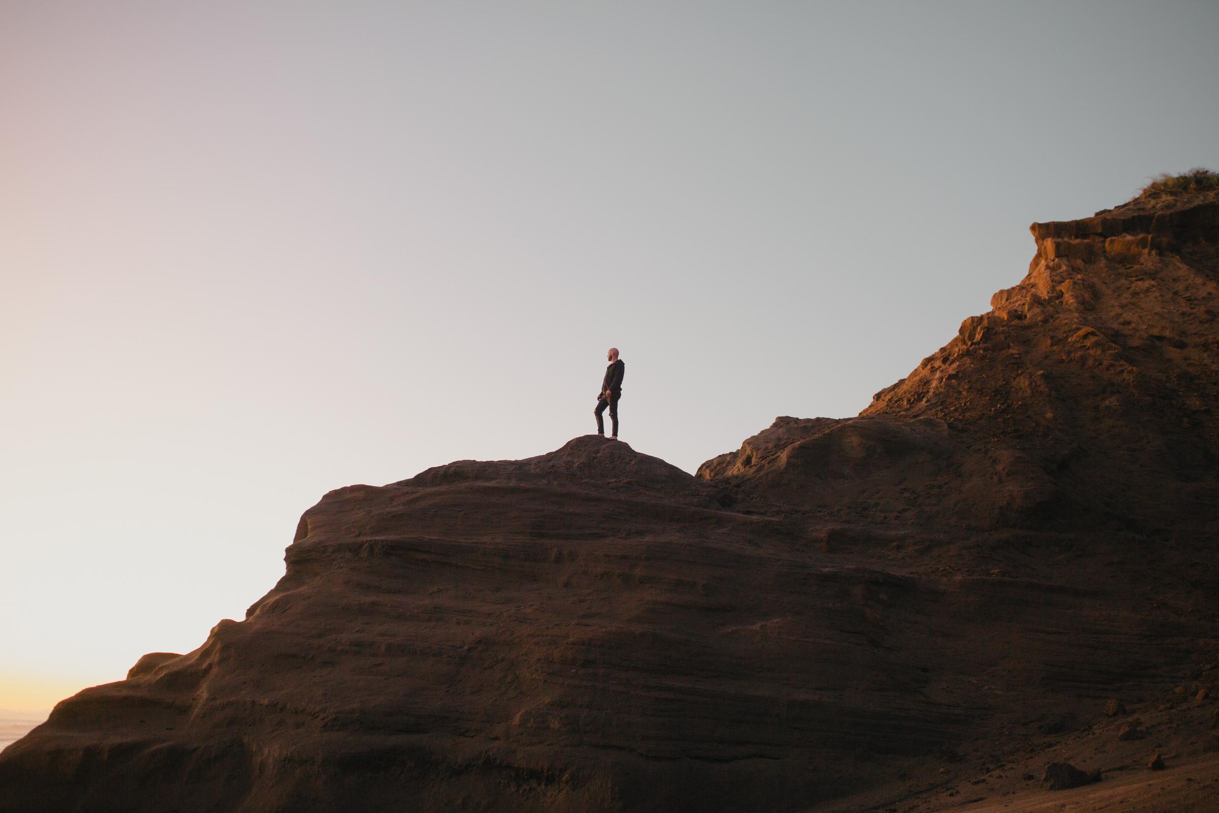 Gian Hart silhouetted against a golden sunset